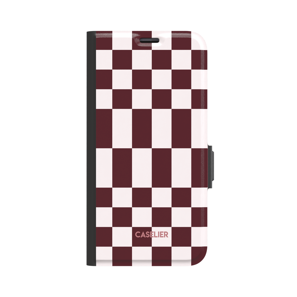 Elonged Checkers folio wallet case in deep burgundy and pale blush pink checkerboard pattern, front cover closed with dark charcoal spine and magnetic clasp, white background, phone case by Caselier - wallet case, front view | Caselier