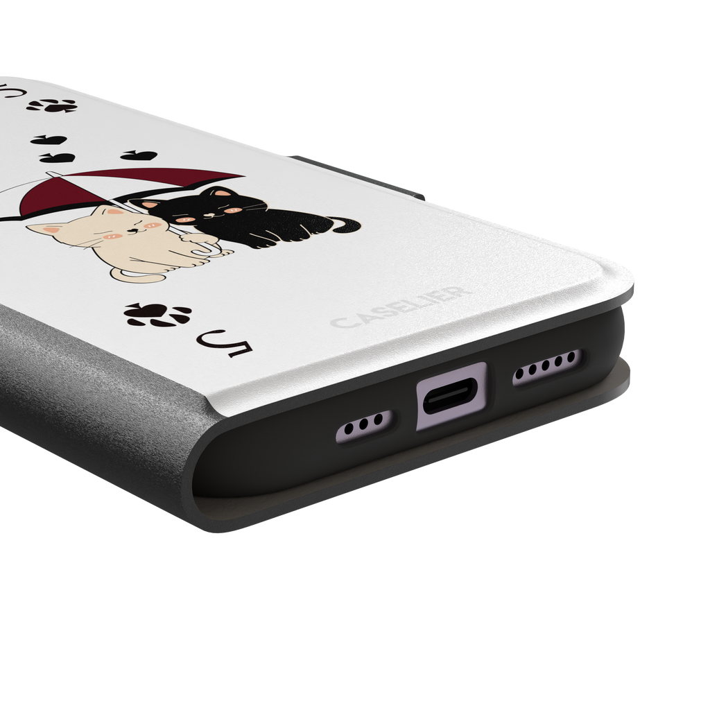 Five of Spades phone case in white with two cartoon cats under a burgundy umbrella, black falling hearts and paw print spade symbols — white colorway variant, phone case by Caselier — wallet case, charging port detail