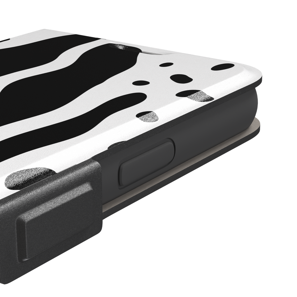 Frog phone case color variant in white with large bold black cow-style animal print patches, phone case by Caselier — wallet case, volume buttons detail
