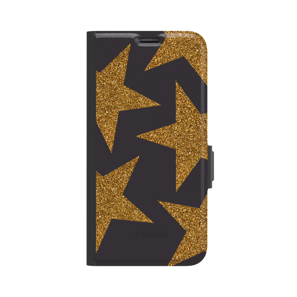 Front view of a folio wallet phone case featuring oversized gold glitter stars on a black background, black spine and magnetic clasp visible, white background, phone case by Caselier - wallet case, front view | Caselier