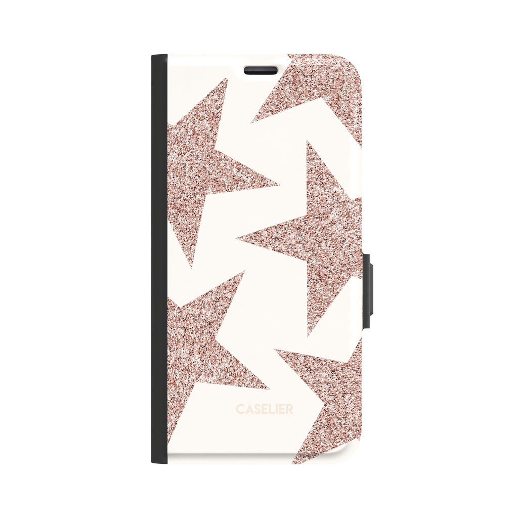 Front view of a folio wallet phone case featuring oversized rose gold glitter stars on a cream background, black spine and magnetic clasp visible, white background, phone case by Caselier - wallet case, front view | Caselier