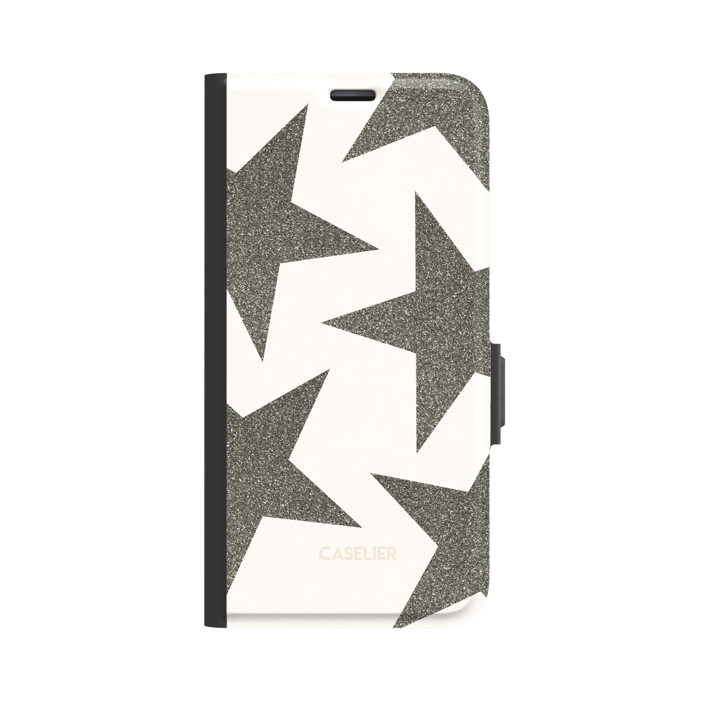 Front view of a folio wallet phone case featuring oversized silver-grey glitter stars on a cream background, black spine and magnetic clasp visible, white background, phone case by Caselier - wallet case, front view | Caselier