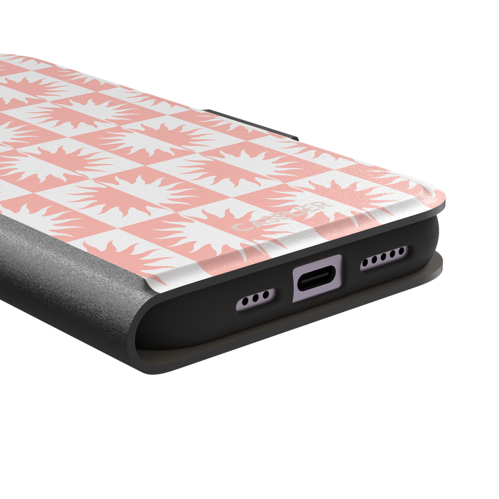 Half-Sun phone case in blush pink and white checkerboard pattern with repeating jagged sun motifs, phone case by Caselier — wallet case, charging port detail