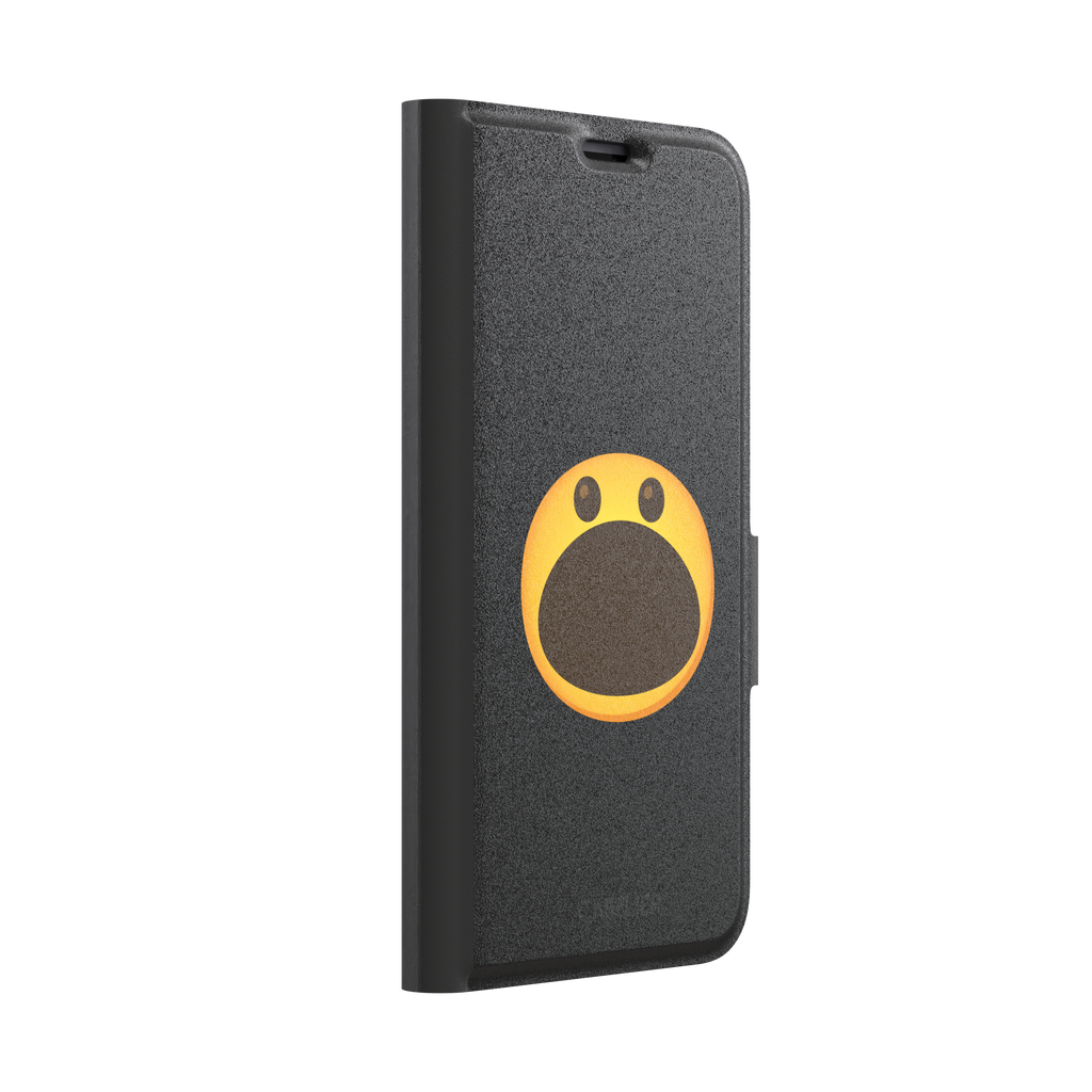 Hungry phone case featuring a bold yellow wide-mouthed screaming emoji on a matte black background, phone case by Caselier — wallet case, left view