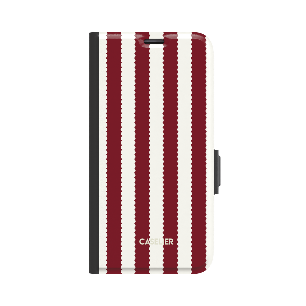 Jagged Stripes folio wallet case in deep red and off-white, broad vertical stripes with wavy zigzag edges, closed folio style with black spine and side clasp, front-facing view on white background, phone case by Caselier - wallet case, front view | Caselier