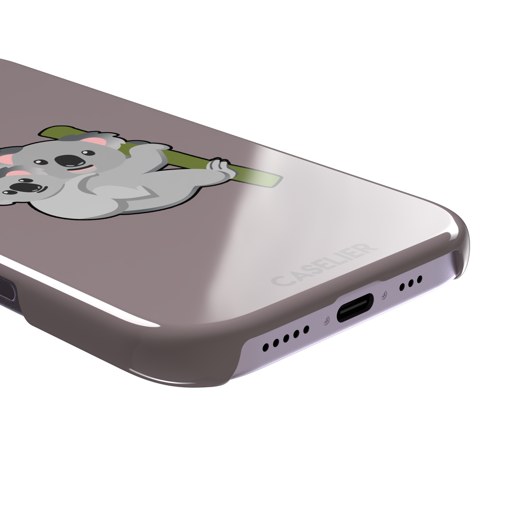 Mauve phone case with a kawaii illustration of a mama koala and baby joey clinging to a green eucalyptus branch, phone case by Caselier — snap case, charging port detail