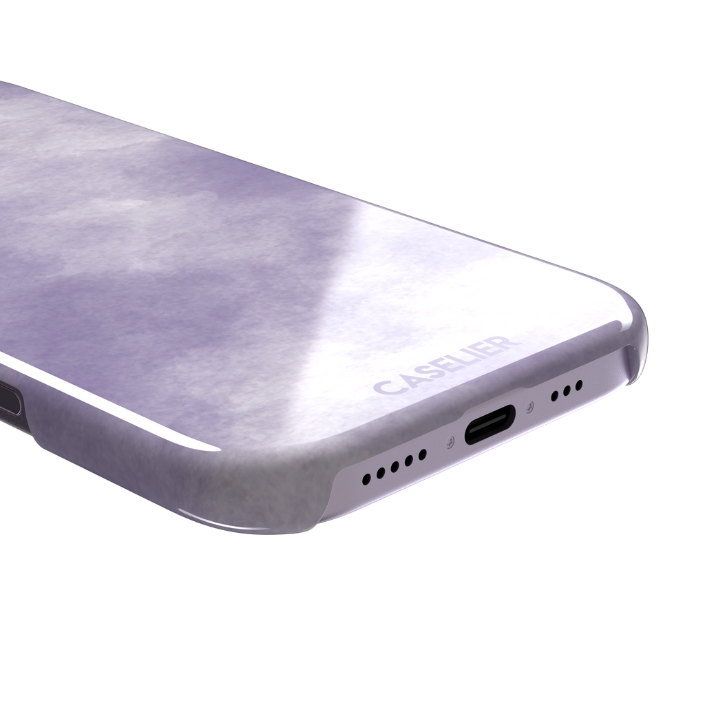 Lavender soft purple watercolor phone case with dreamy white cloud-like blends on an iPhone, phone case by Caselier — snap case, charging port detail