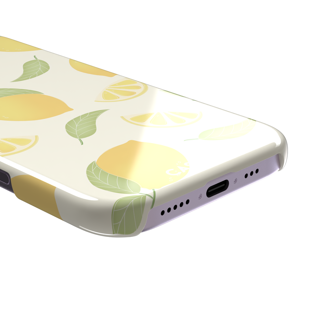 Lemons phone case with a cream background featuring golden whole lemons, lemon slices, and sage green leaves in a repeat pattern, phone case by Caselier — snap case, charging port detail
