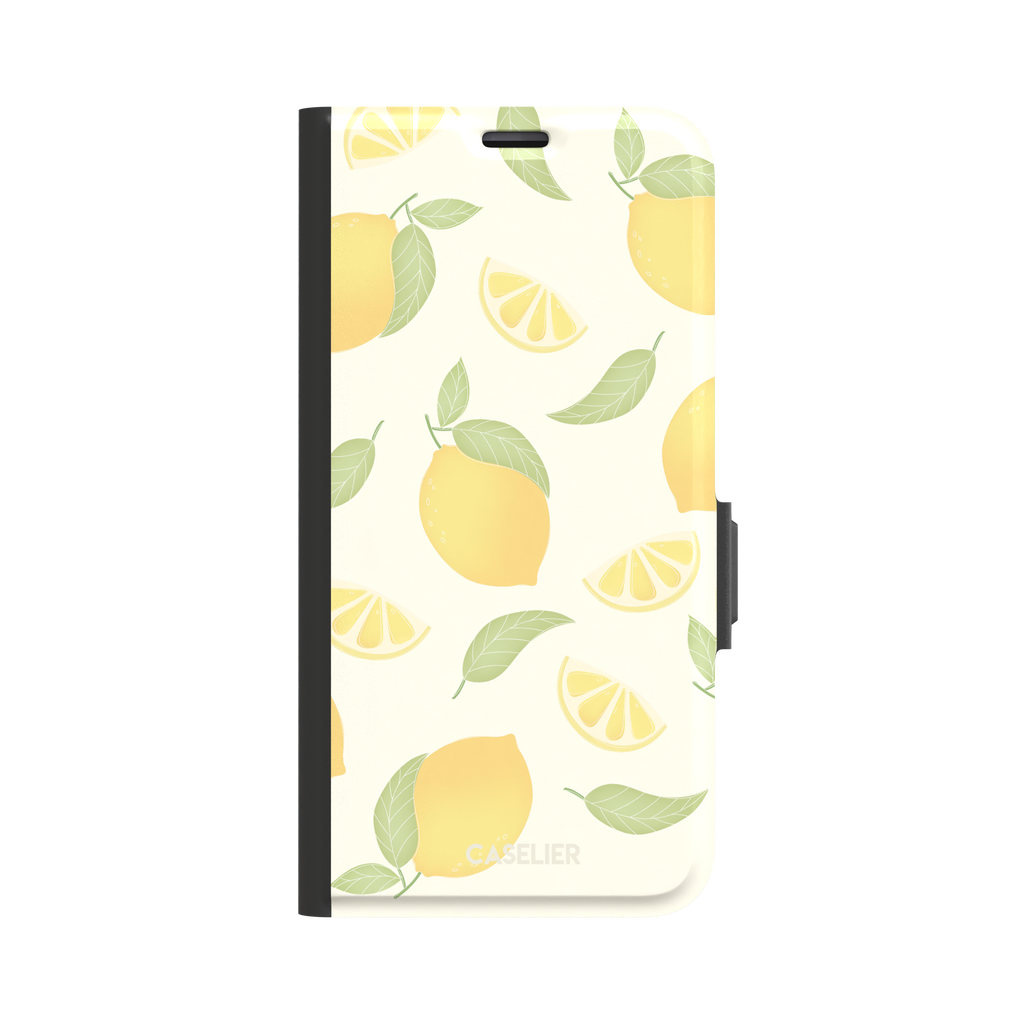 Lemons phone case with a cream background featuring golden whole lemons, lemon slices, and sage green leaves in a repeat pattern, phone case by Caselier — wallet case, front view