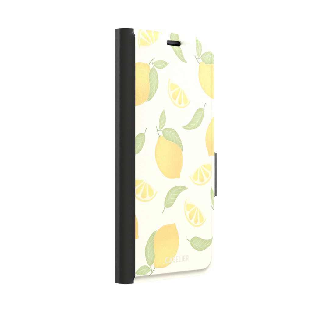 Lemons phone case with a cream background featuring golden whole lemons, lemon slices, and sage green leaves in a repeat pattern, phone case by Caselier — wallet case, left view