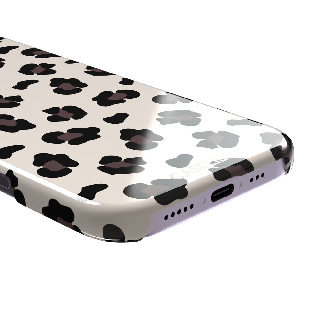 Leopard print phone case in black and dark brown spots on warm cream background, color variant, phone case by Caselier — snap case, charging port detail
