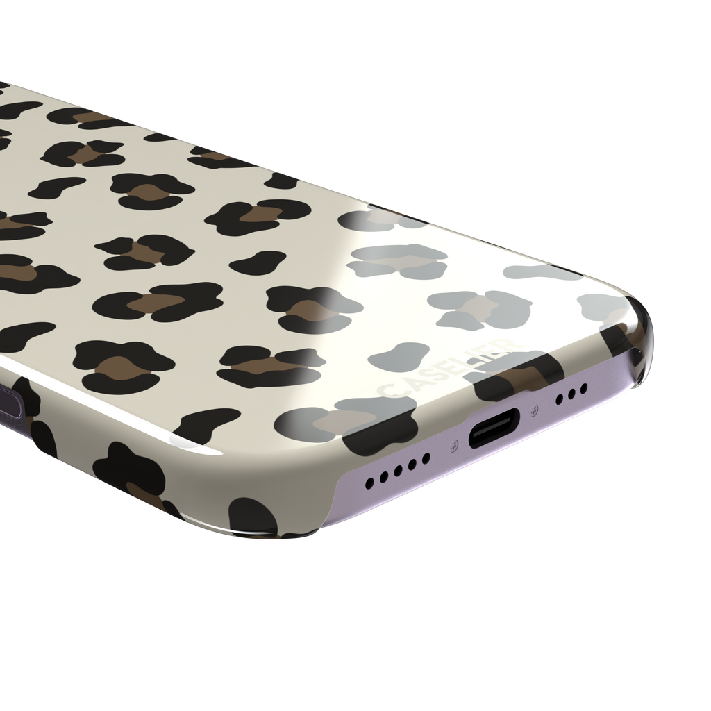 Leopard print phone case in black and medium brown spots on light beige background, color variant, phone case by Caselier — snap case, charging port detail