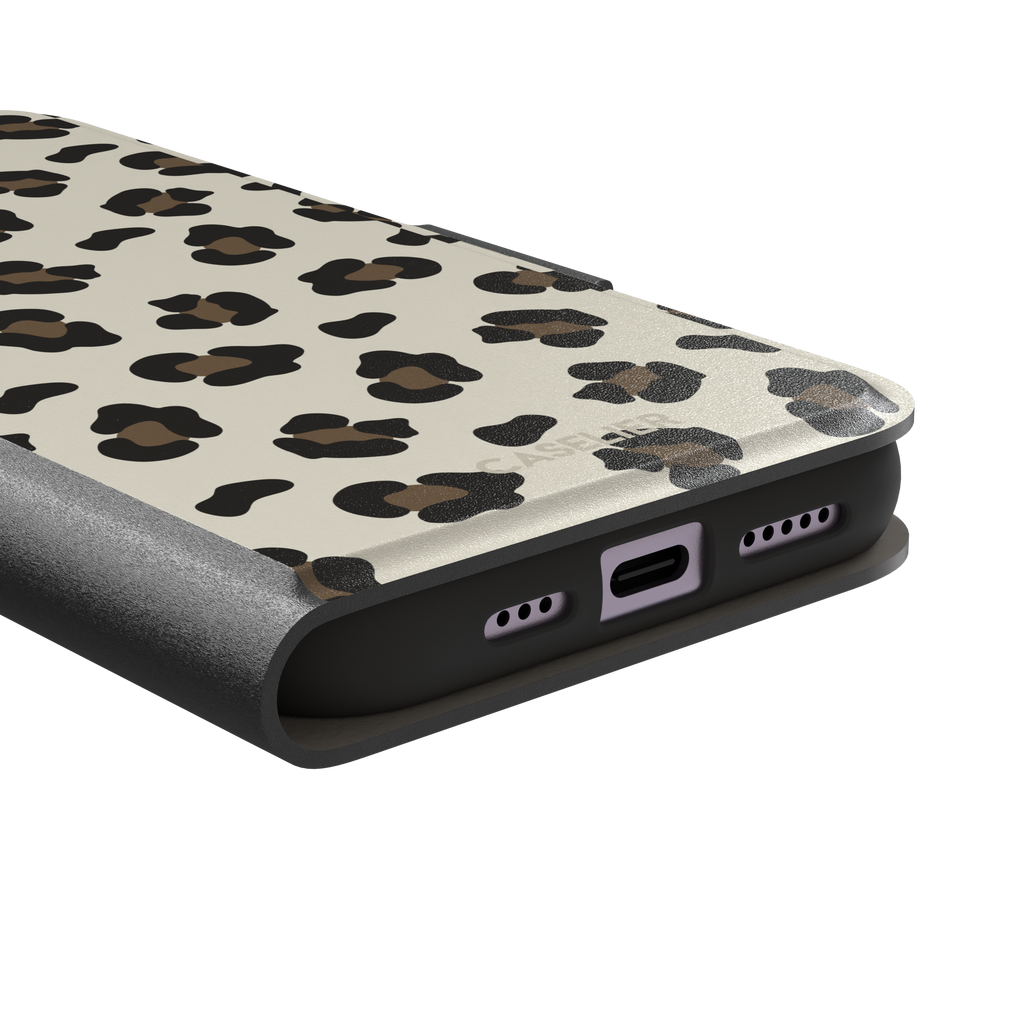 Leopard print phone case in black and medium brown spots on light beige background, color variant, phone case by Caselier — wallet case, charging port detail