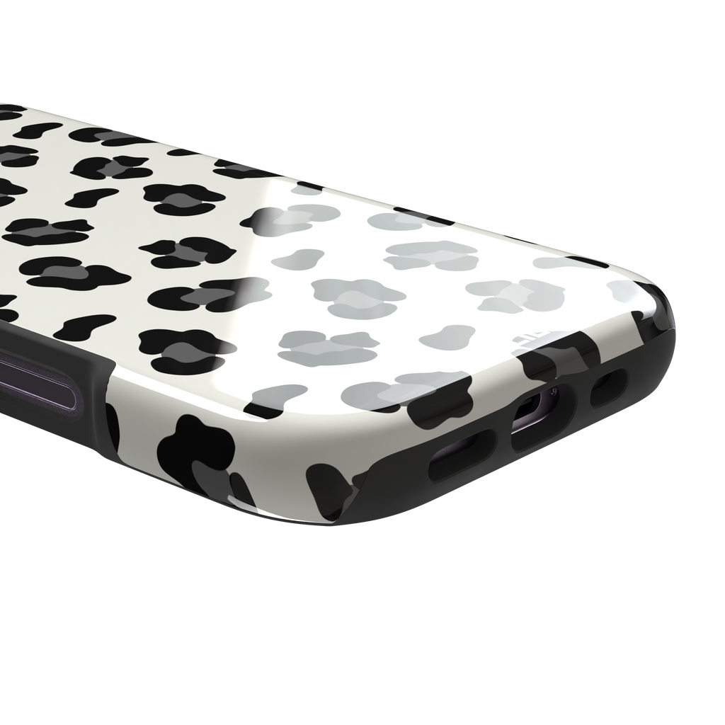 Leopard print phone case in black spots on off-white background, primary product shot, phone case by Caselier — tough case, charging port detail