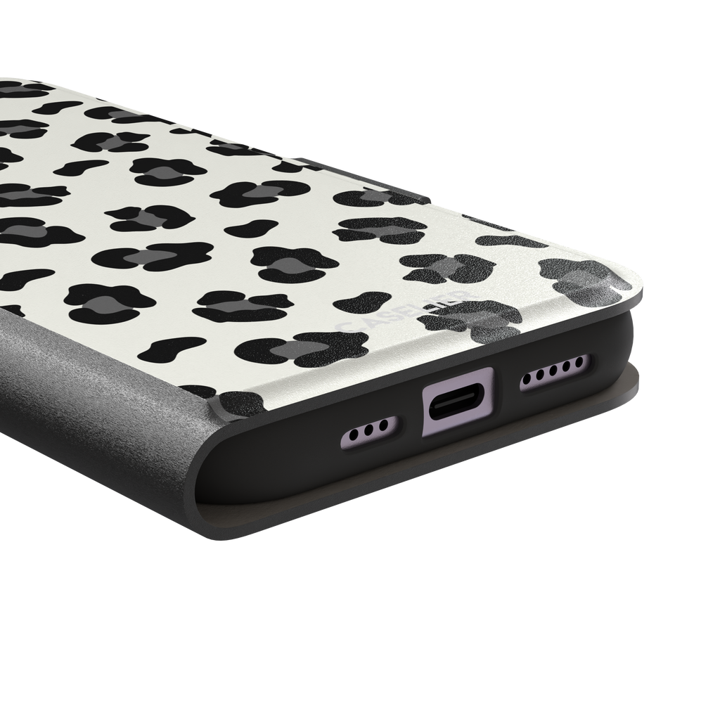 Leopard print phone case in black spots on off-white background, primary product shot, phone case by Caselier — wallet case, charging port detail