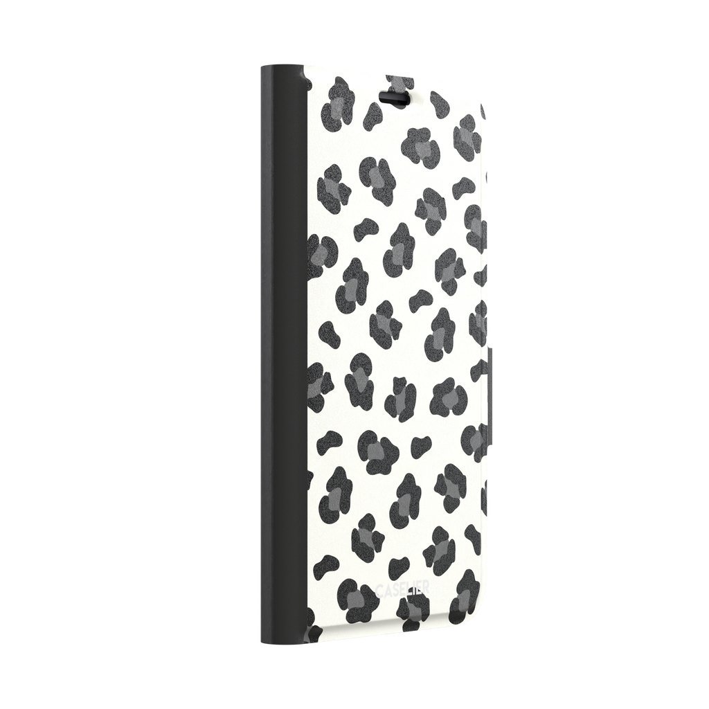 Leopard print phone case in black spots on off-white background, primary product shot, phone case by Caselier — wallet case, left view