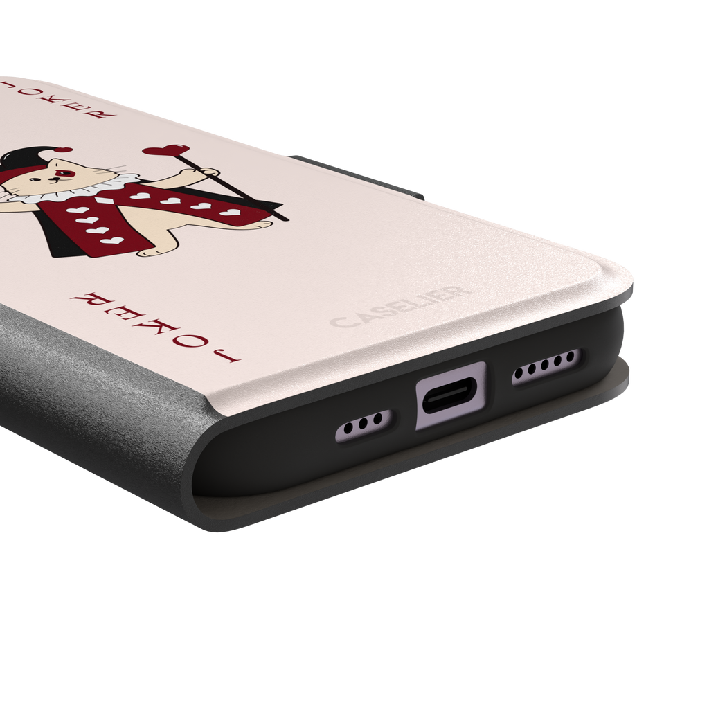Lord of Jokers phone case in blush pink featuring an illustrated cat dressed as a joker in a crimson heart-patterned robe and black jester hat, holding a heart staff, styled as a playing card with JOKER lettered vertically in dark red, front view, phone case by Caselier — wallet case, charging port detail