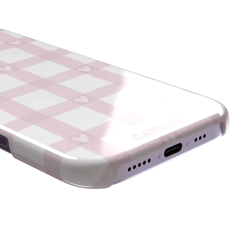 Lovely Grid phone case in soft pink gingham with scattered white hearts, phone case by Caselier — snap case, charging port detail