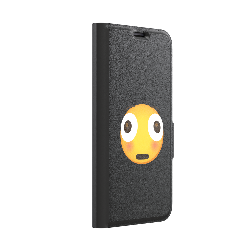 Moments Before Disaster phone case featuring a large flushed emoji face with wide eyes and rosy cheeks on a matte black background, phone case by Caselier — wallet case, left view