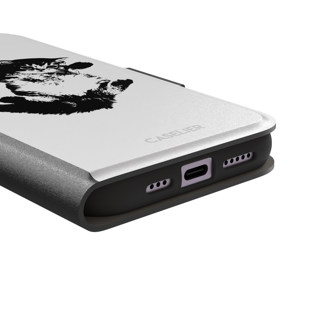 White phone case with a bold black-and-white ink-style illustration of a fluffy kitten lying on its back with paws raised, phone case by Caselier — wallet case, charging port detail