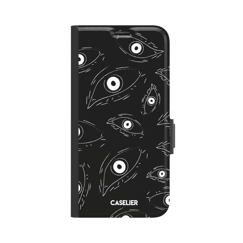 Paranoia phone case in black with all-over white hand-drawn staring eyes and sharp angular lashes, phone case by Caselier — wallet case, front view