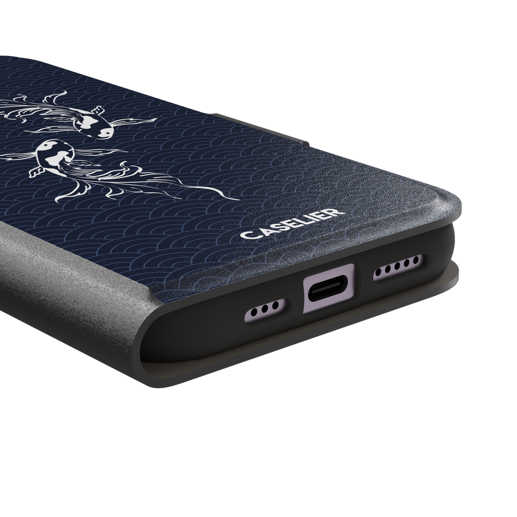 Playful Fishies phone case featuring two white koi fish in line-art style on a deep navy Japanese seigaiha wave pattern, phone case by Caselier — wallet case, charging port detail