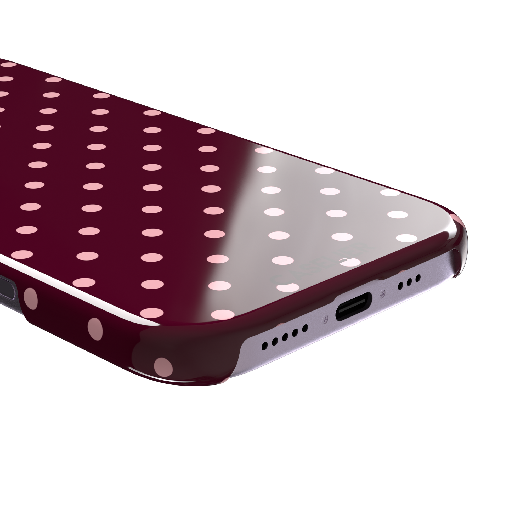 Polka dot phone case in deep burgundy with blush pink spots arranged in a classic evenly spaced grid, phone case by Caselier — snap case, charging port detail