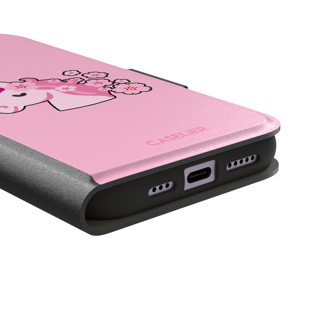 Pink phone case featuring a cute cartoon unicorn with a striped horn and a cherry blossom-filled mane on a bubblegum pink background, phone case by Caselier — wallet case, charging port detail