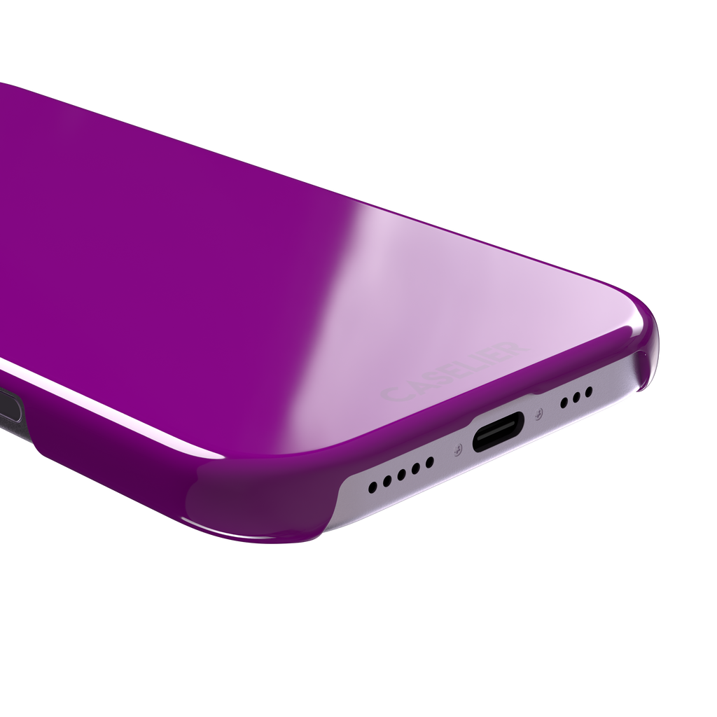 Solid magenta-purple phone case in a vivid, warm fuchsia-purple tone, phone case by Caselier — snap case, charging port detail