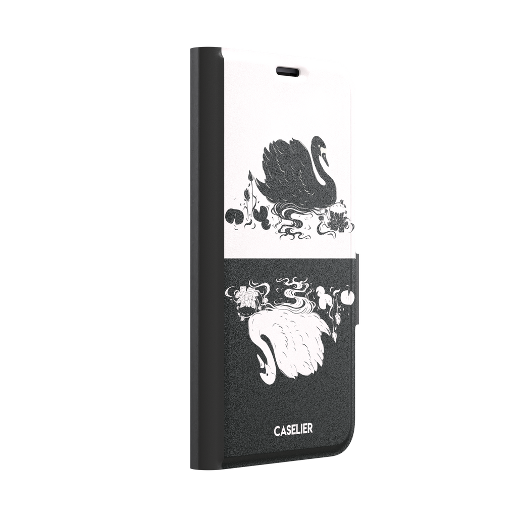 Reflection phone case in inverted colorway with a black swan on a cream upper half and a white swan on a deep black lower half, with matching lotus and water motifs — wallet case, left view
