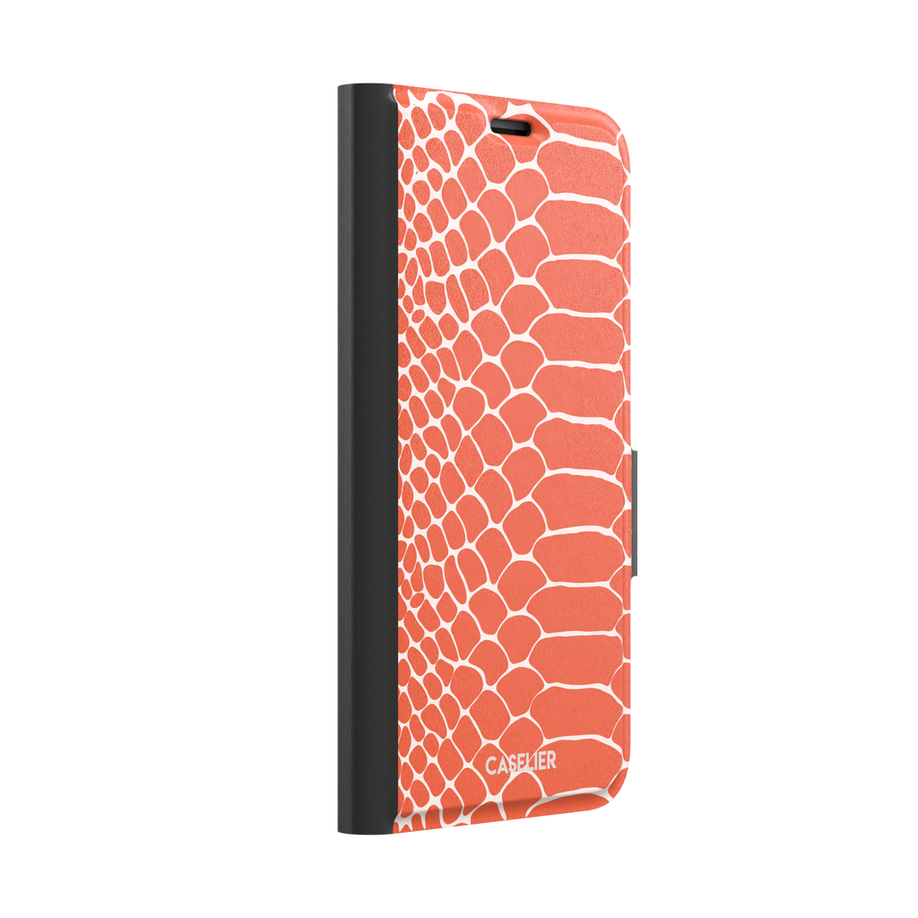 Coral orange and white snakeskin print phone case with crisp off-white scale outlines on a bold orange background, phone case by Caselier — wallet case, left view
