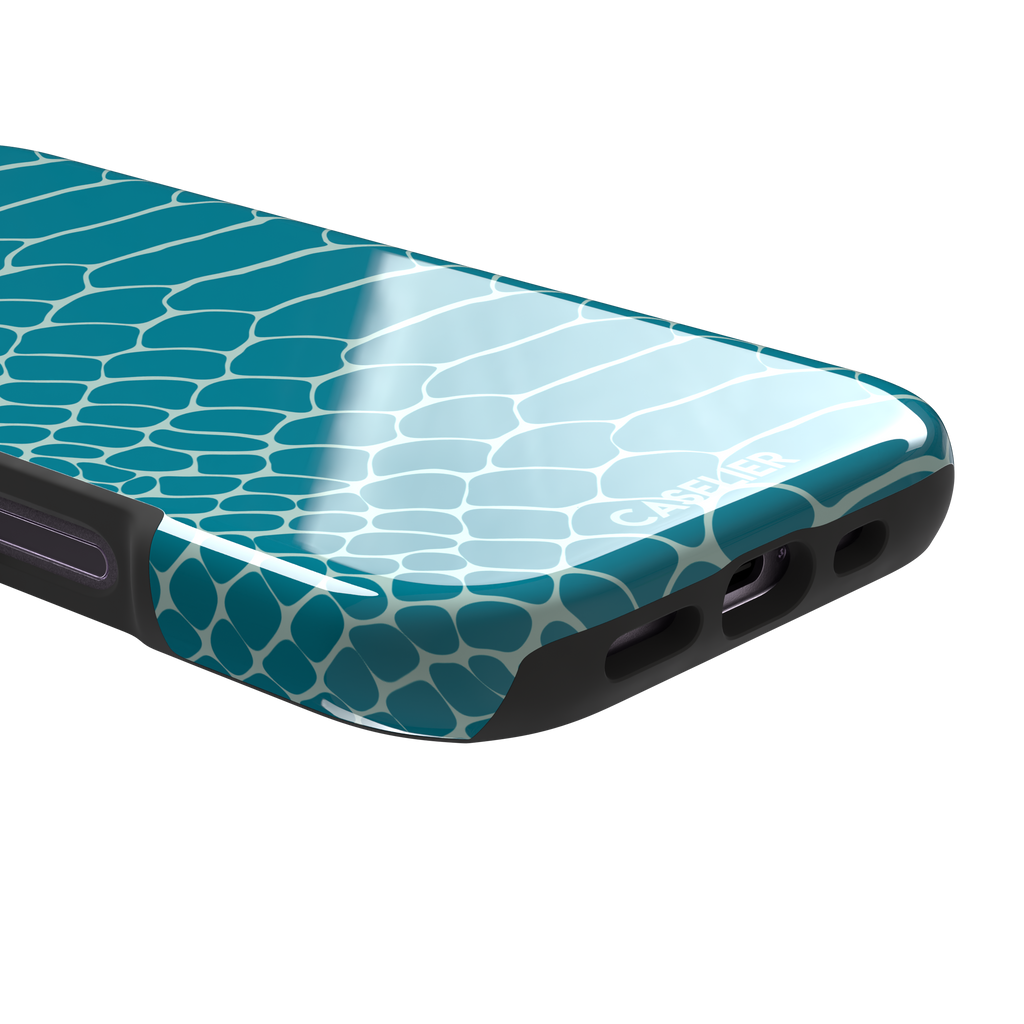 Teal and white snakeskin print phone case with bold reptile scale pattern covering the full back, phone case by Caselier — tough case, charging port detail