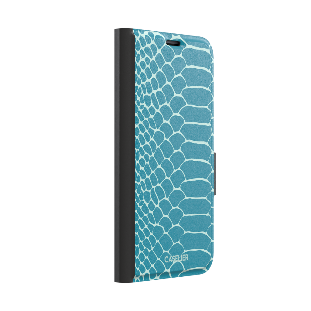 Teal and white snakeskin print phone case with bold reptile scale pattern covering the full back, phone case by Caselier — wallet case, left view