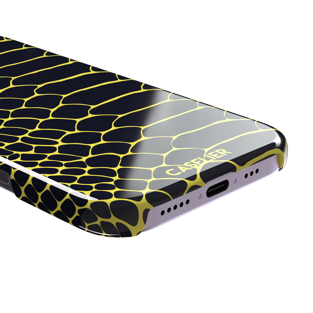 Navy and yellow snakeskin print phone case with vivid yellow scale outlines on a deep dark blue background, phone case by Caselier — snap case, charging port detail