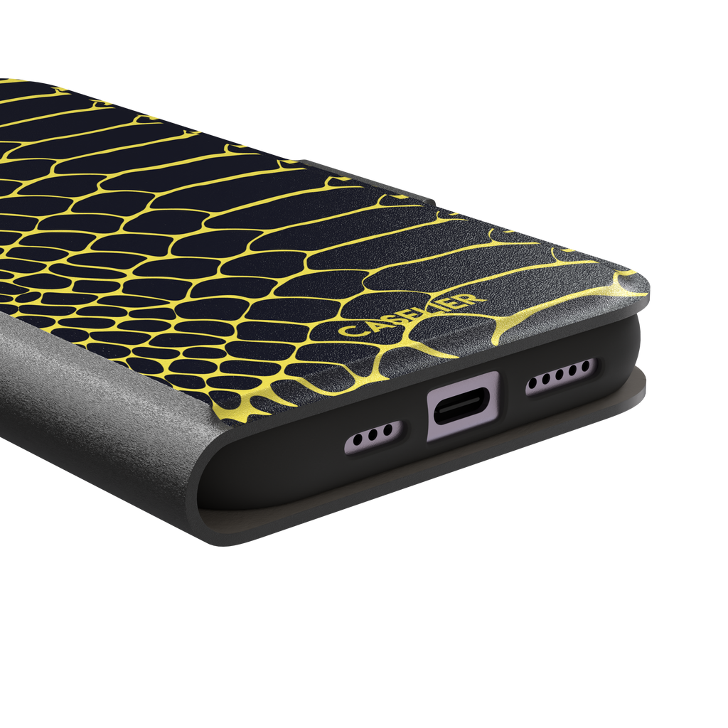Navy and yellow snakeskin print phone case with vivid yellow scale outlines on a deep dark blue background, phone case by Caselier — wallet case, charging port detail