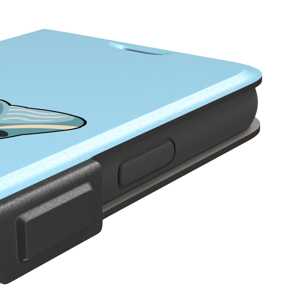 Sky-blue phone case featuring a cute cartoon humpback whale breaching from splashing waves, rendered in teal and cream with bold outlines, phone case by Caselier — wallet case, volume buttons detail