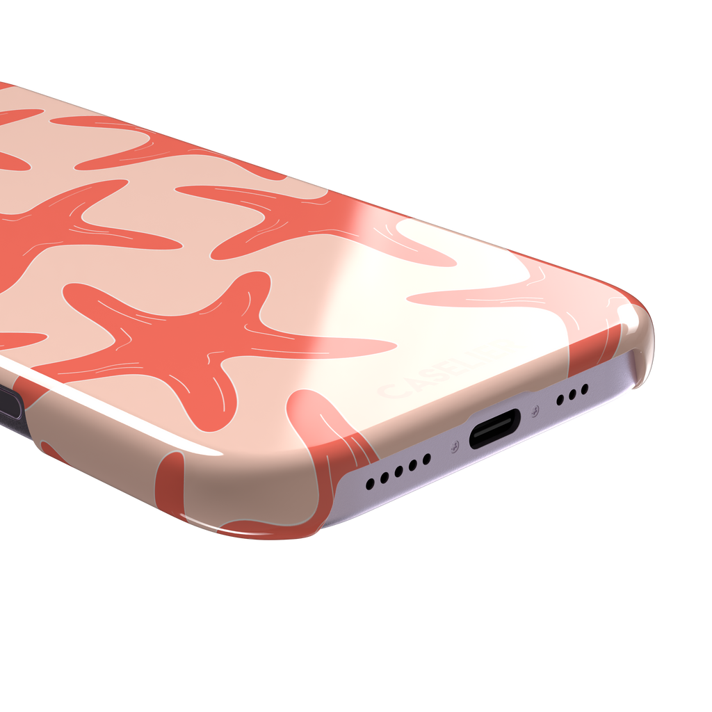Starfish phone case with bold coral starfish pattern on a soft peach background, part of the Memories of Summer collection, phone case by Caselier — snap case, charging port detail