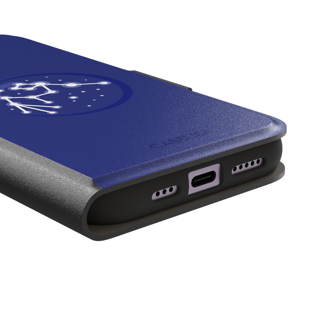 Starsigns phone case showing the Scorpio constellation as a glowing white star map inside a blue orb on a cobalt blue case, phone case by Caselier — wallet case, charging port detail