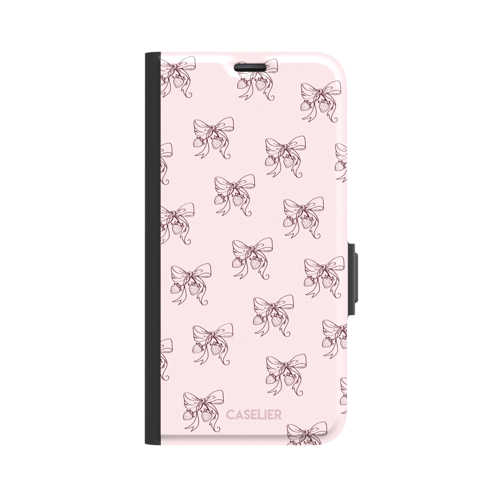 Strawberry Bows phone case in blush pink with an all-over pattern of line-drawn ribbon bows and hanging strawberries, phone case by Caselier — wallet case, front view