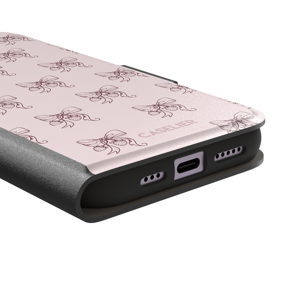 Strawberry Bows phone case in blush pink with an all-over pattern of line-drawn ribbon bows and hanging strawberries, phone case by Caselier — wallet case, charging port detail