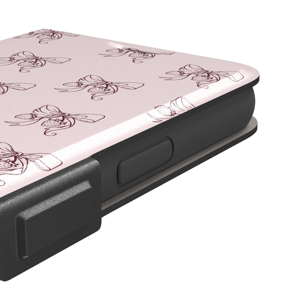 Strawberry Bows phone case in blush pink with an all-over pattern of line-drawn ribbon bows and hanging strawberries, phone case by Caselier — wallet case, volume buttons detail