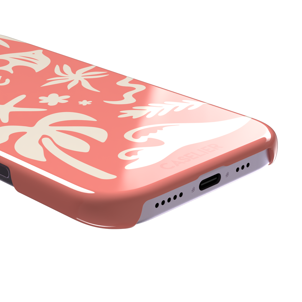 Summer Time phone case in coral pink with cream tropical cutout silhouettes including palm trees, starfish, waves and a fish, phone case by Caselier — snap case, charging port detail