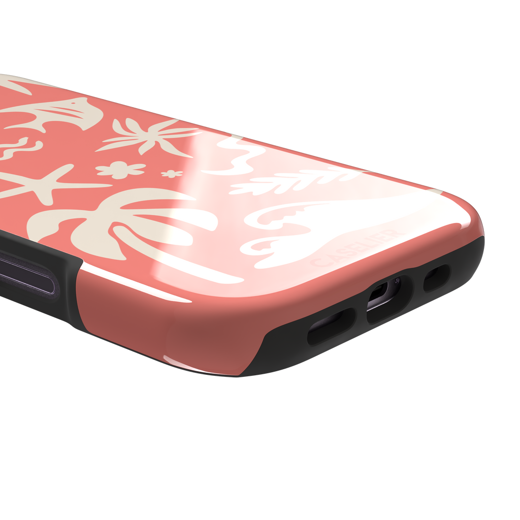 Summer Time phone case in coral pink with cream tropical cutout silhouettes including palm trees, starfish, waves and a fish, phone case by Caselier — tough case, charging port detail