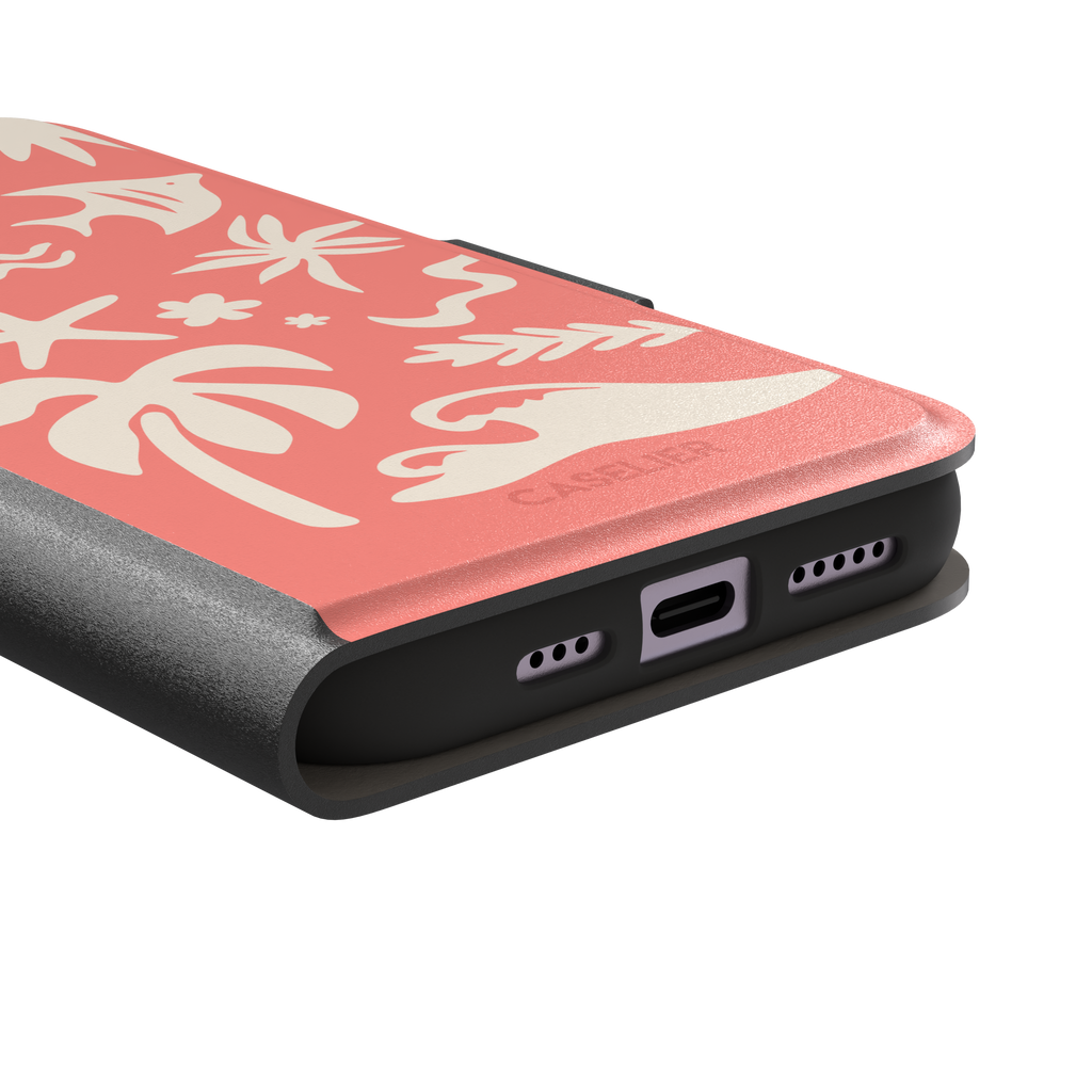 Summer Time phone case in coral pink with cream tropical cutout silhouettes including palm trees, starfish, waves and a fish, phone case by Caselier — wallet case, charging port detail