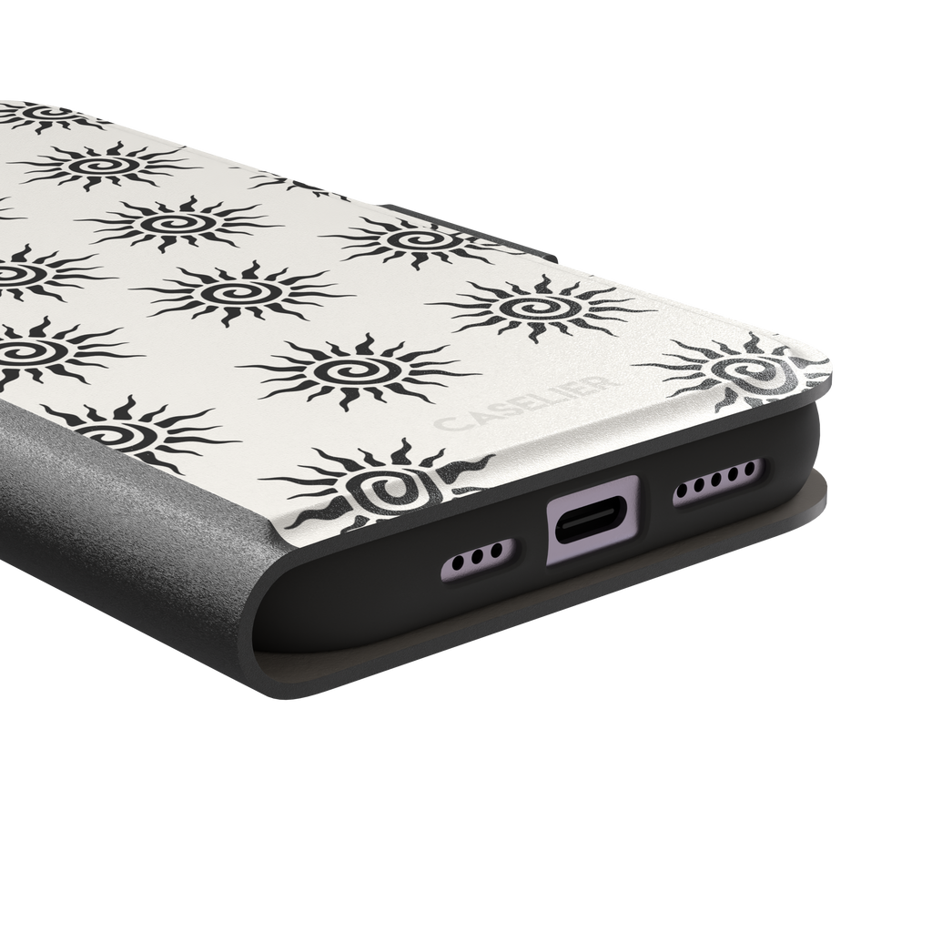 Sunkissed phone case in black and white with repeating tribal spiral sun pattern on a crisp white background, phone case by Caselier — wallet case, charging port detail
