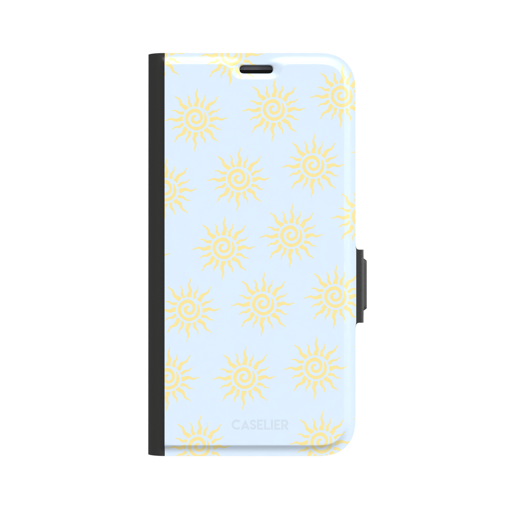 Sunkissed phone case color variant with golden yellow tribal spiral suns on a soft powder blue background, phone case by Caselier — wallet case, front view
