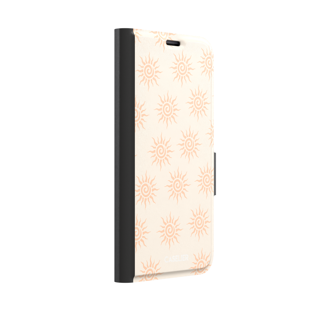 Sunkissed phone case color variant with pale peach tribal spiral suns on a warm cream background, phone case by Caselier — wallet case, left view