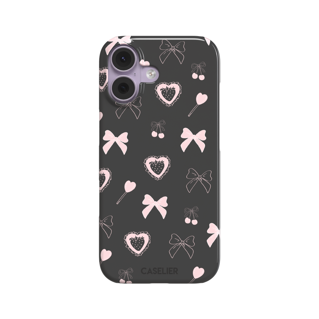 Sweetness Overload phone case in dark charcoal grey with pink bows, cherries, heart lollipops and frilled strawberry heart illustrations — snap case, front view