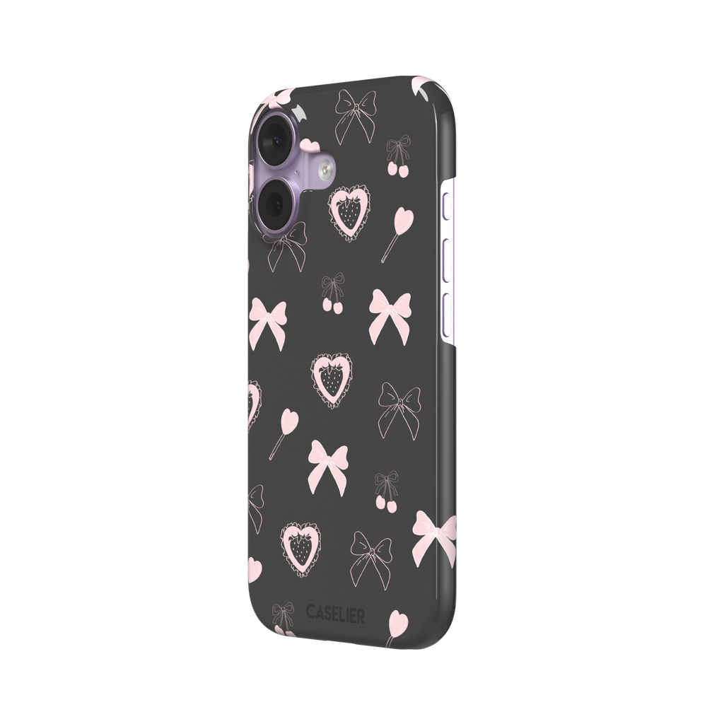 Sweetness Overload phone case in dark charcoal grey with pink bows, cherries, heart lollipops and frilled strawberry heart illustrations — snap case, right view