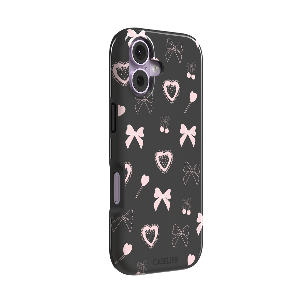 Sweetness Overload phone case in dark charcoal grey with pink bows, cherries, heart lollipops and frilled strawberry heart illustrations — tough case, left view